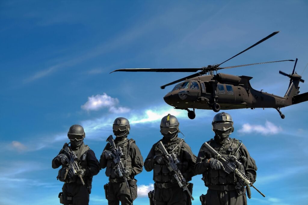 Four soldiers with guns and a helicopter above