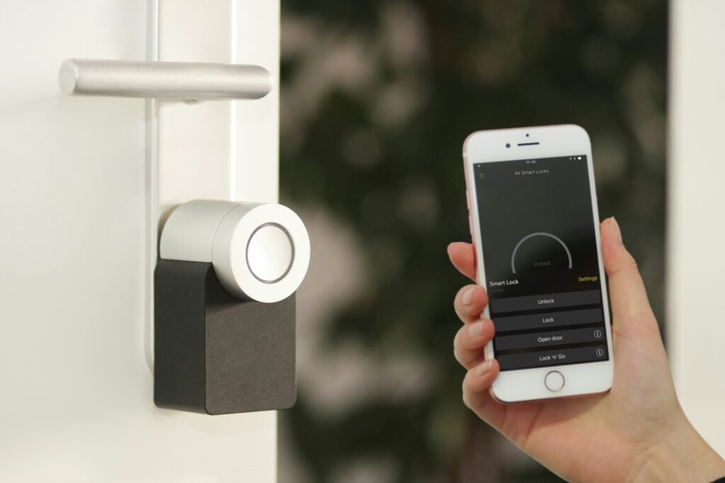Hand holding smart phone to a door